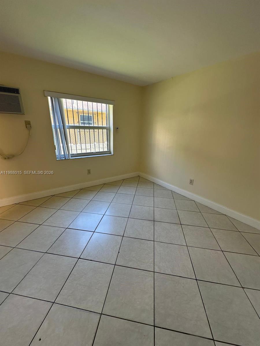 100 Northeast 78th Street, Unit 4 Miami, FL 33138 - Photo 10 of 12 a view of an empty room and window