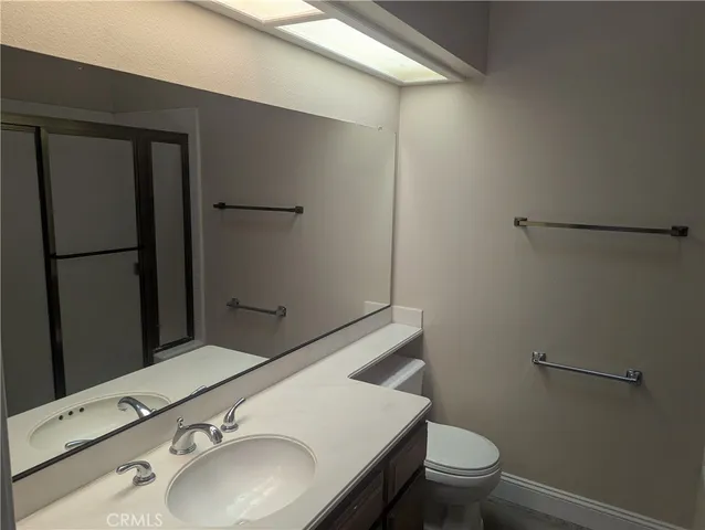 a bathroom with a sink toilet and vanity