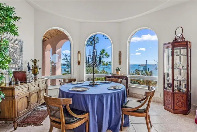 a dining hall with furniture a large window and a sink