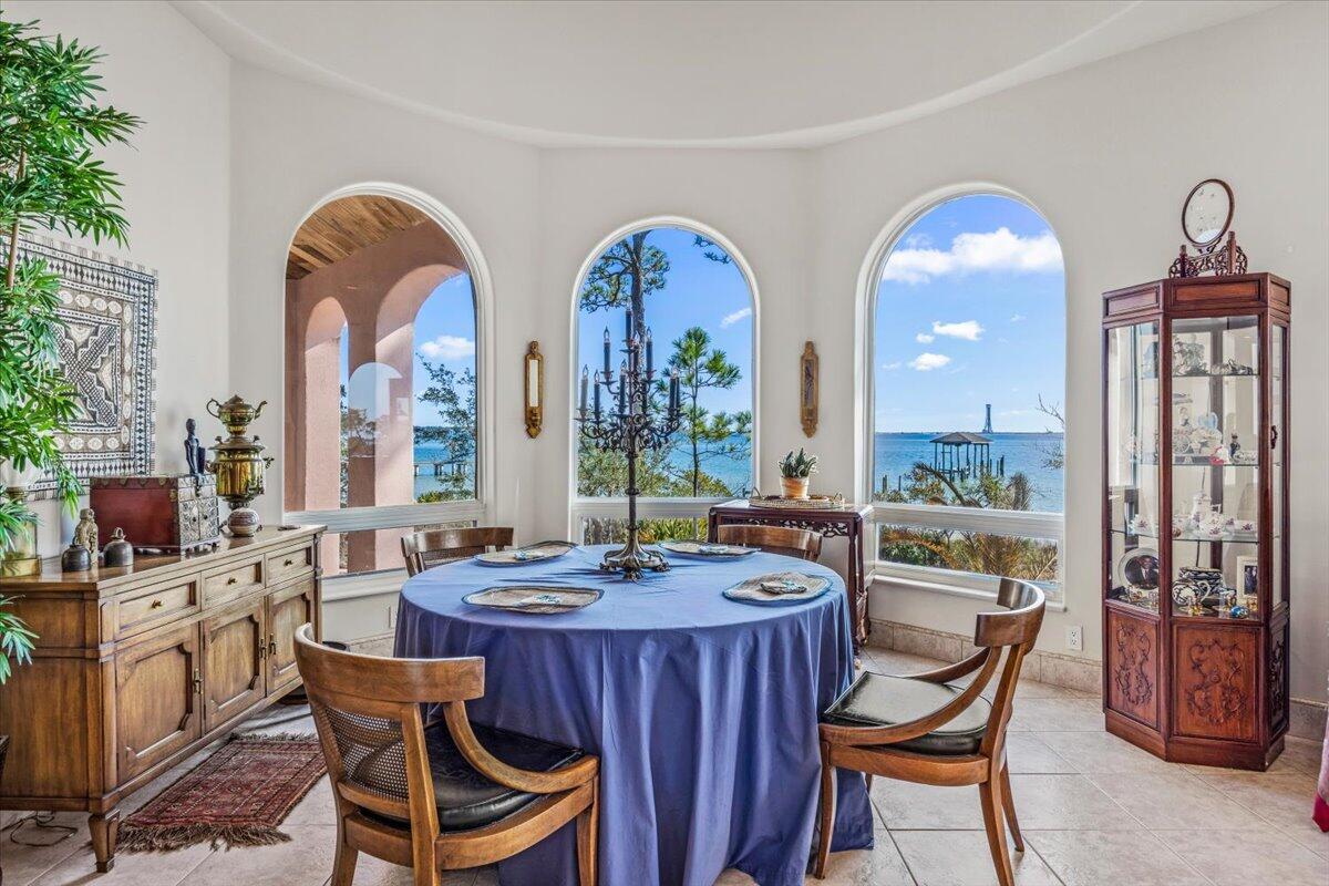 a dining hall with furniture a large window and a sink