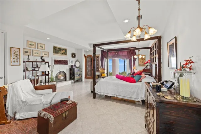 a bedroom with furniture and a chandelier