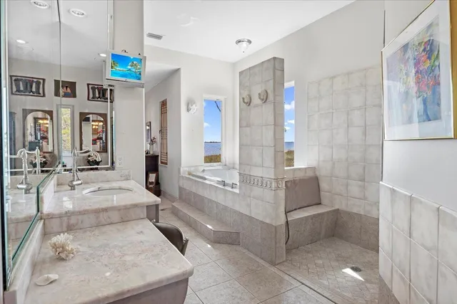 a bathroom with a tub sink and mirror