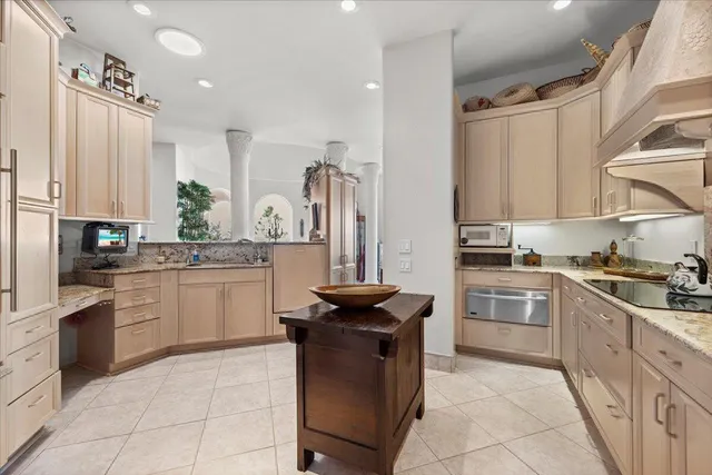 a kitchen with granite countertop a sink stainless steel appliances and cabinets