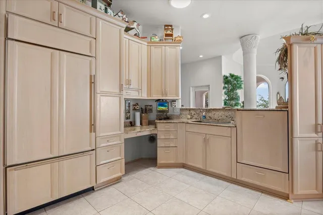 a kitchen with white cabinets and white appliances