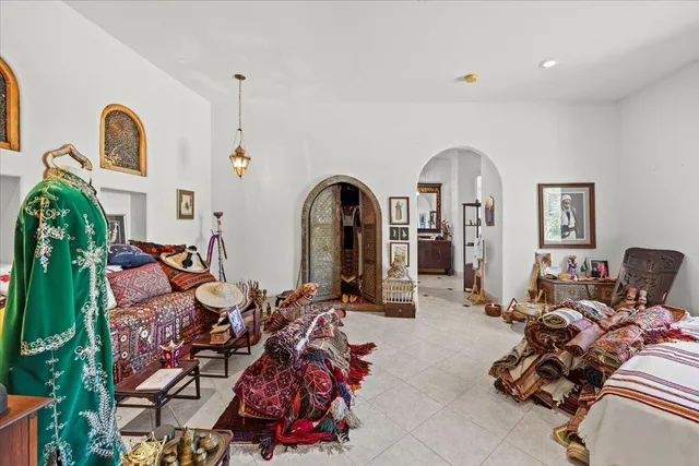 a living room with furniture a fireplace and potted plants