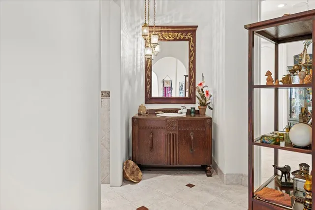 a view of a hallway with two windows and potted plants