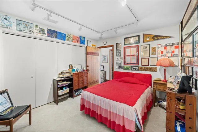 a bedroom with bed and a book shelf