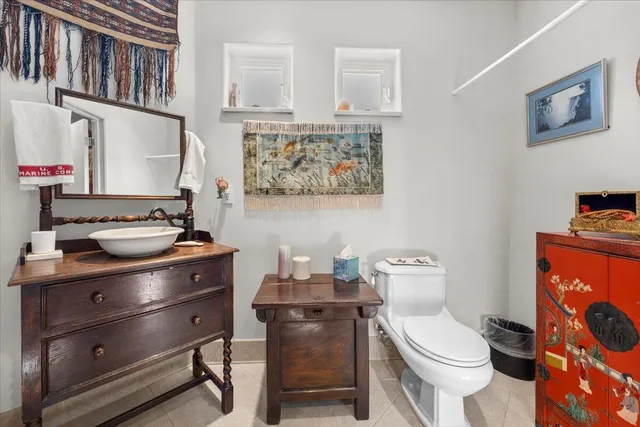 a bathroom with a toilet a sink and a mirror