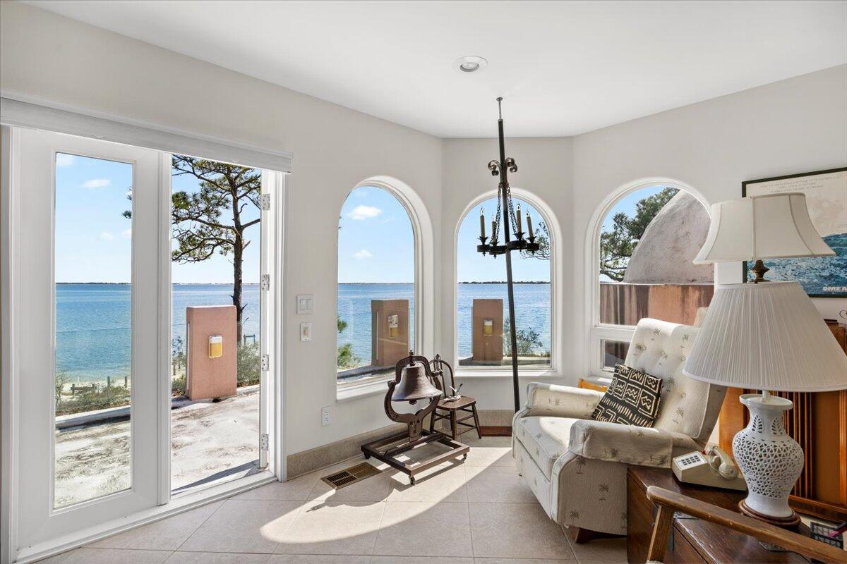 221 Wynnehaven Beach Road Mary Esther, FL 32569 - Photo 31 of 35 a living room with furniture a window and a chandelier
