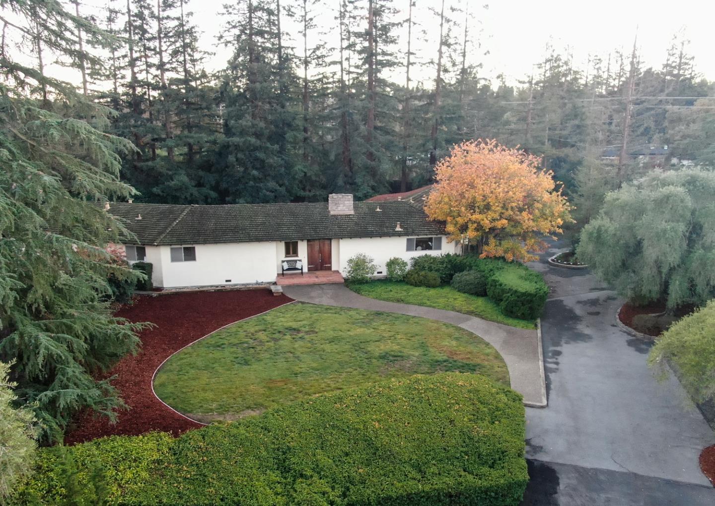 a view of a house with a yard and street