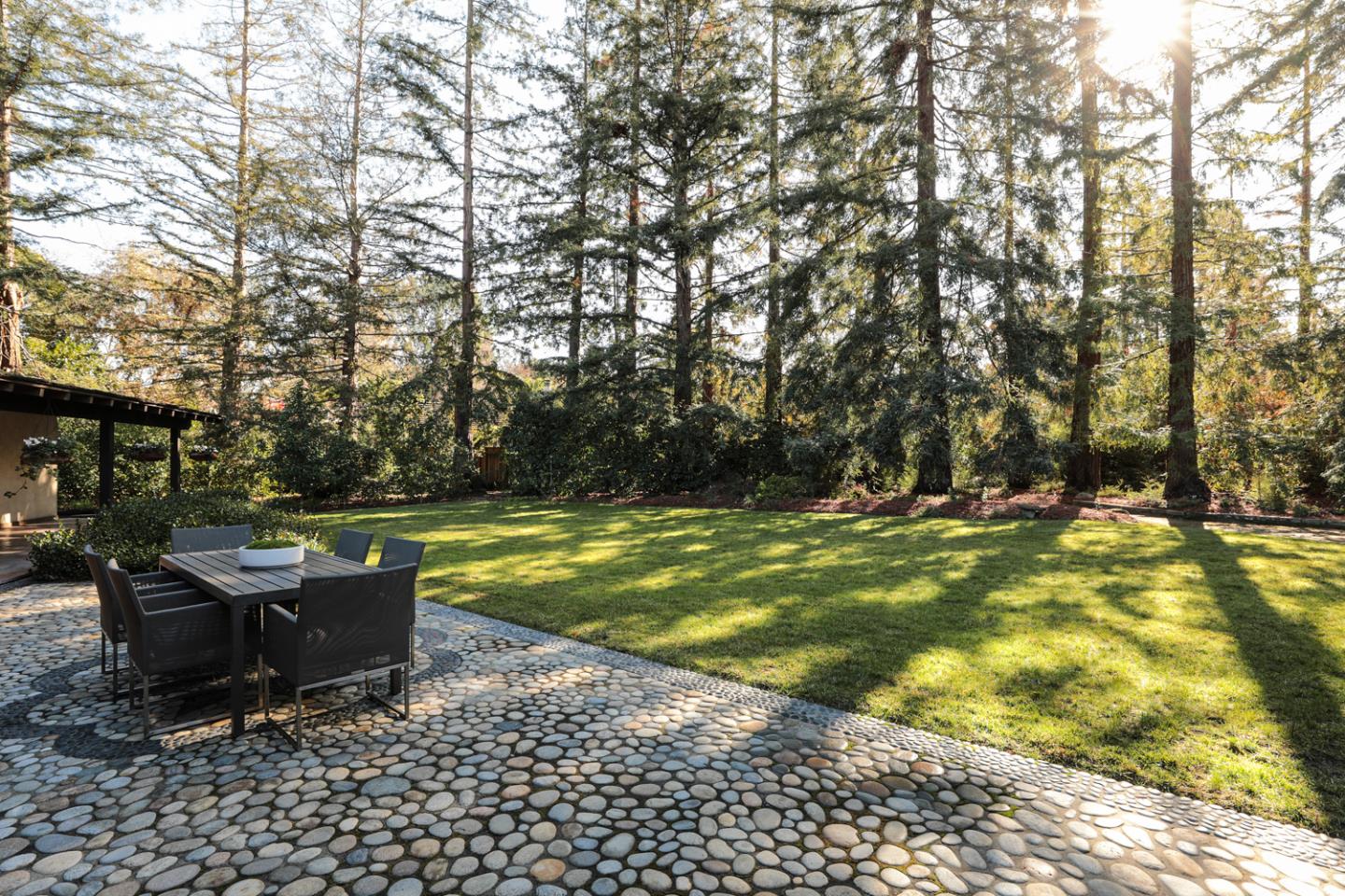 95 Mulberry Lane Atherton, CA 94027 - Photo 20 of 26 a view of a swimming pool with lawn chairs under an umbrella