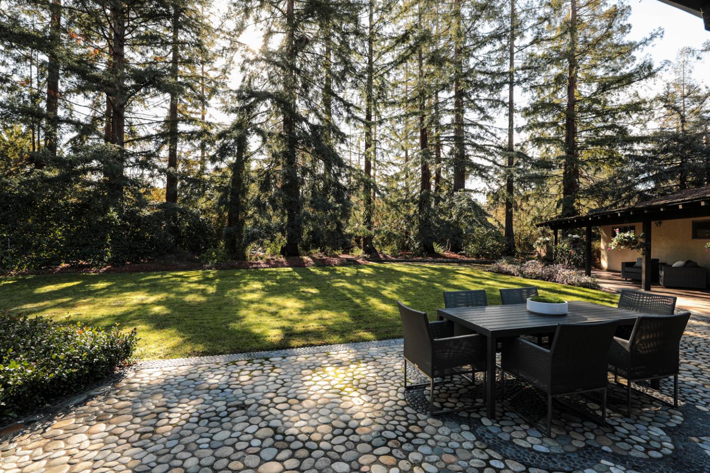 95 Mulberry Lane Atherton, CA 94027 - Photo 21 of 26 a view of a swimming pool with lawn chairs under an umbrella