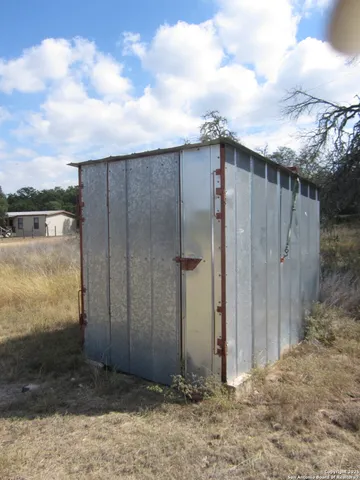 a view of a wooden fence next to a yard