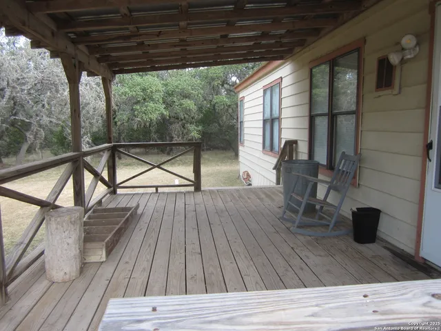 a view of balcony with wooden floor and outdoor seating