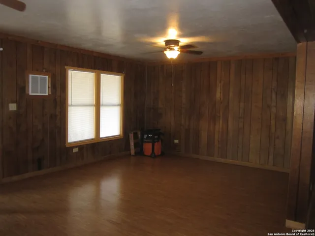 a view of a livingroom with furniture and chandelier fan