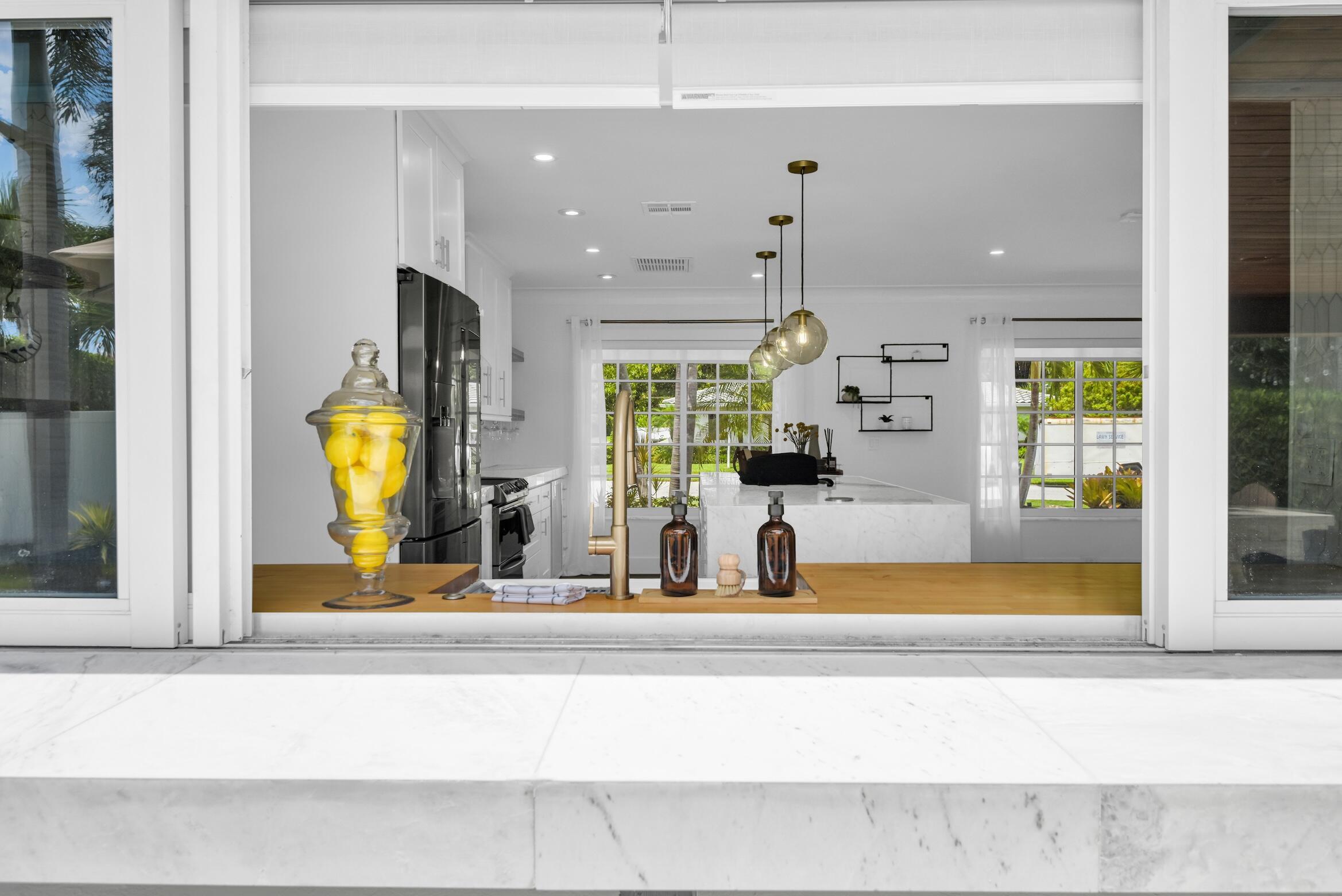 701 Appleby Street Boca Raton, FL 33487 - Photo 11 of 47 a view of a living room with a large window and chandelier