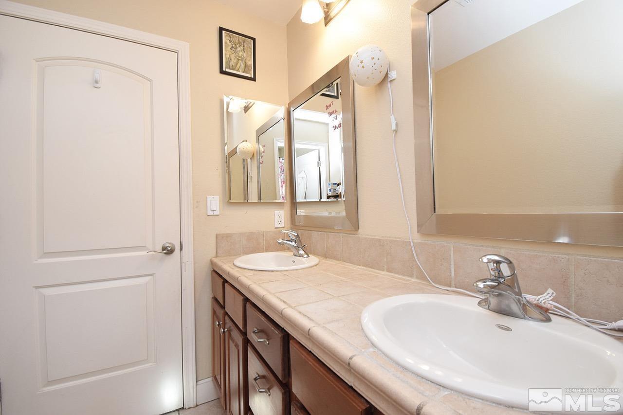 2735 Gulling Court Reno, NV 89503 - Photo 18 of 30 a bathroom with a sink and a mirror