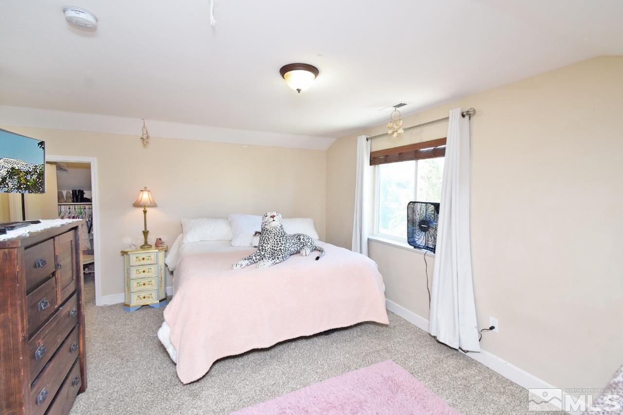 2735 Gulling Court Reno, NV 89503 - Photo 19 of 30 a bedroom with a bed and a night stand