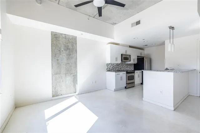 a large kitchen with cabinets and stainless steel appliances