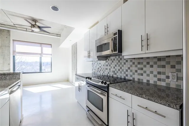 a kitchen that has a stove and a microwave