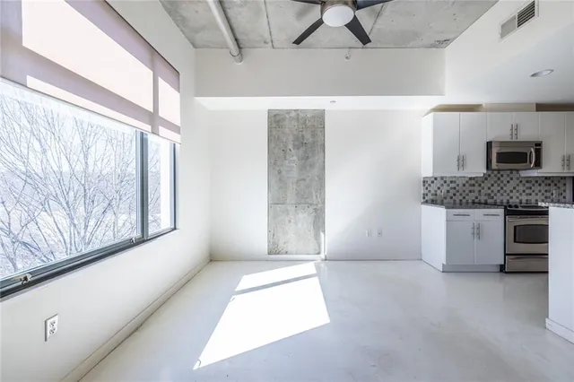 a living room with a fireplace furniture and a large window