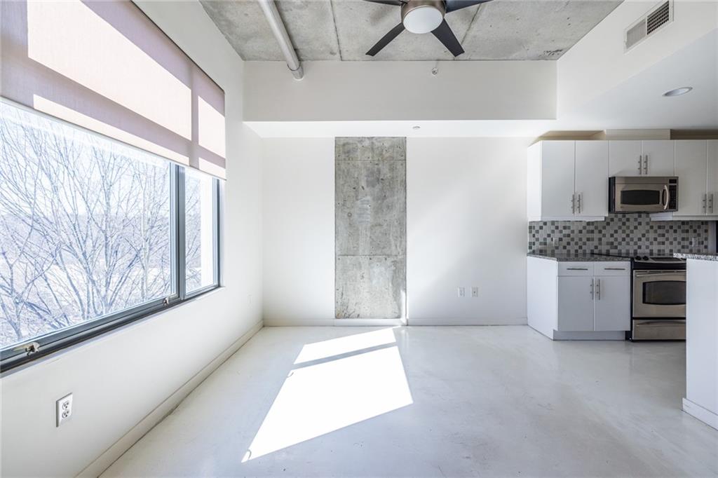 335 West Ponce De Leon Avenue, Unit 506 Decatur, GA 30030 - Photo 23 of 49 a living room with a fireplace furniture and a large window