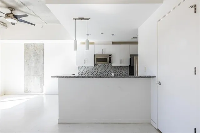 a view of a living room with a fireplace