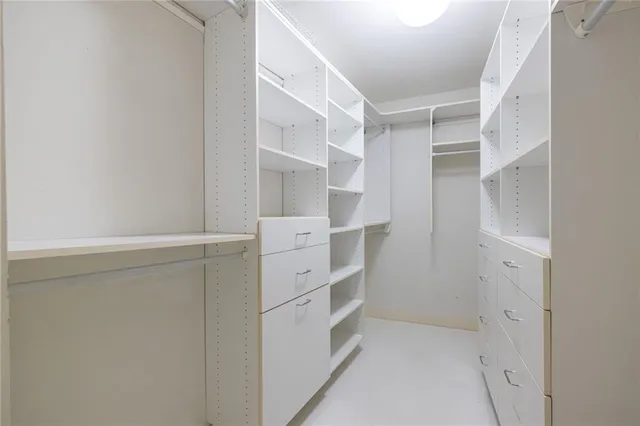 a bathroom with a granite countertop sink a toilet and a mirror