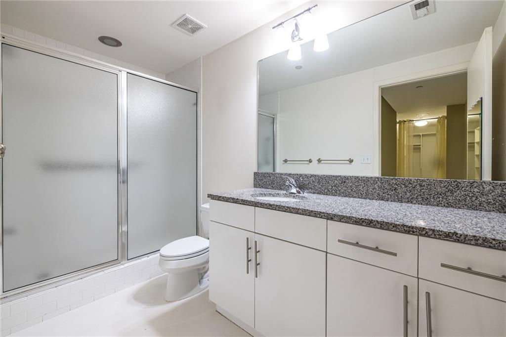 335 West Ponce De Leon Avenue, Unit 506 Decatur, GA 30030 - Photo 35 of 49 a bathroom with a granite countertop sink a toilet and a mirror