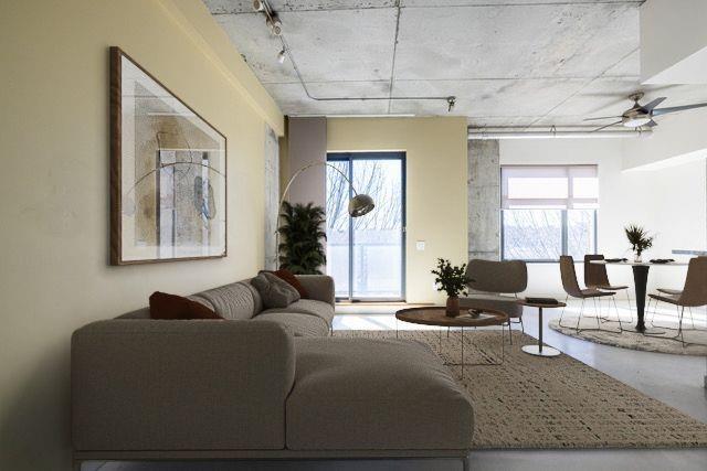 335 West Ponce De Leon Avenue, Unit 506 Decatur, GA 30030 - Photo 4 of 49 a living room with furniture and a painting on the wall