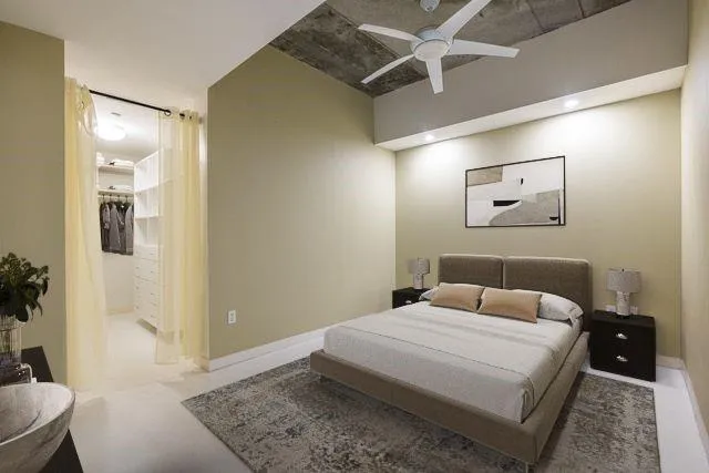 a bedroom with a bed and a mirror