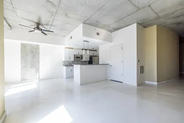 a view of a kitchen with a dishwasher and white cabinets