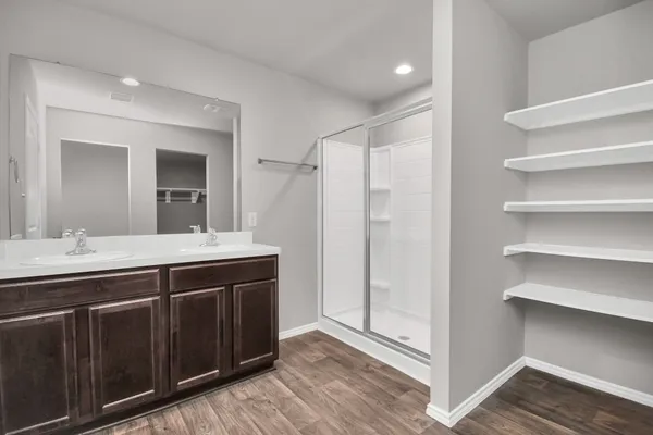 a spacious bathroom with a shower sink and mirror