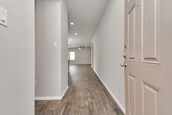 a kitchen with stainless steel appliances kitchen island granite countertop a stove a sink and a refrigerator