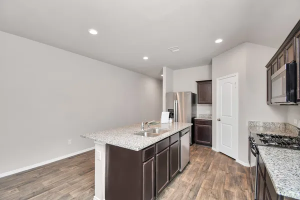 a kitchen with a sink stove and refrigerator