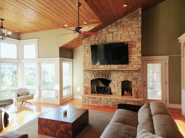 a living room with furniture a fireplace and a flat screen tv