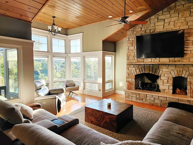 a living room with fireplace furniture and a flat screen tv