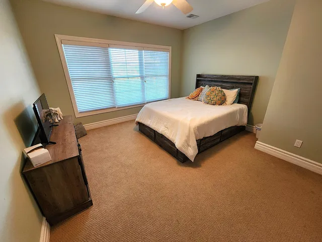 a bedroom with a bed and window