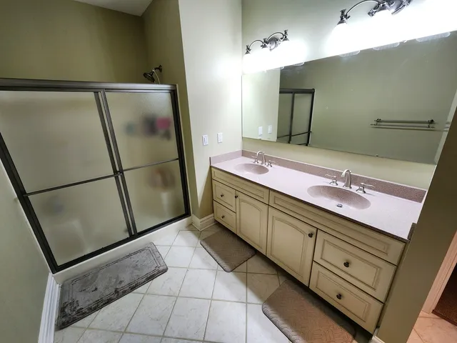a bathroom with a double vanity sink and mirror