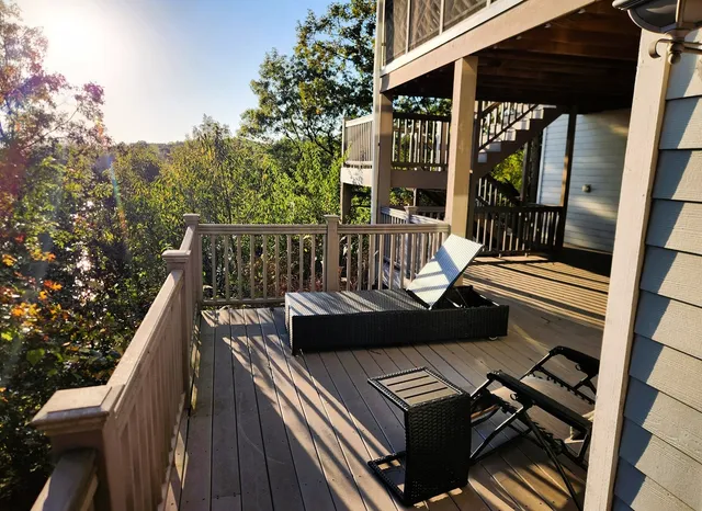 a view of balcony with wooden floor and outdoor seating