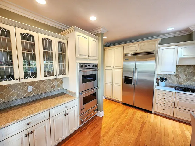 a kitchen with stainless steel appliances a refrigerator and a stove