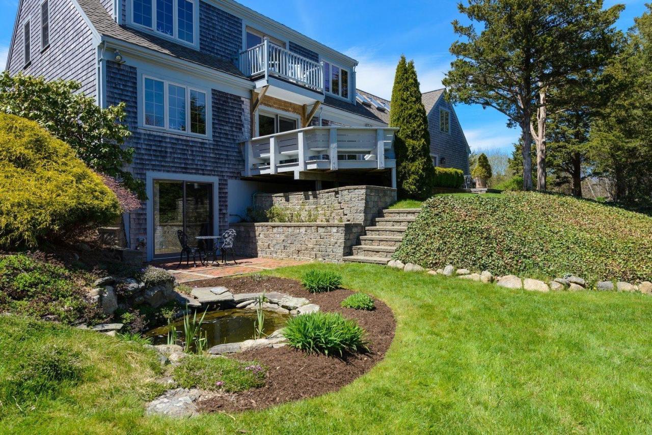 52 Point Hill Road West Barnstable, MA 02668 - Photo 2 of 28 a front view of a house with a yard and shrubs