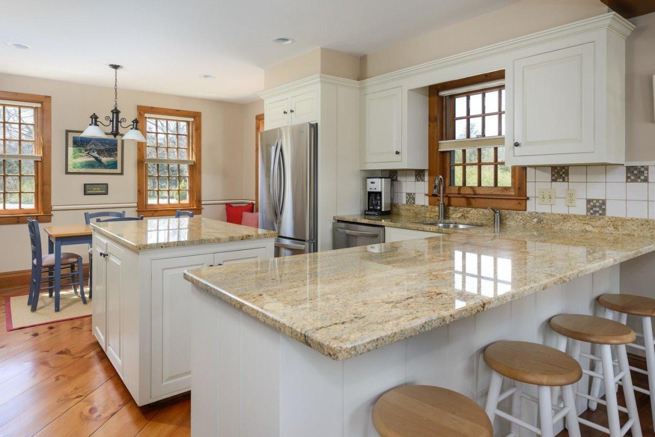 52 Point Hill Road West Barnstable, MA 02668 - Photo 9 of 28 a kitchen with stainless steel appliances granite countertop a stove a sink and a refrigerator
