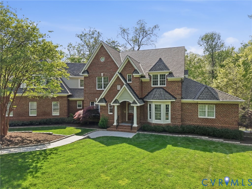 3506 Salles Ridge Court Midlothian, VA 23113 - Photo 2 of 78 a front view of a house with a garden and trees