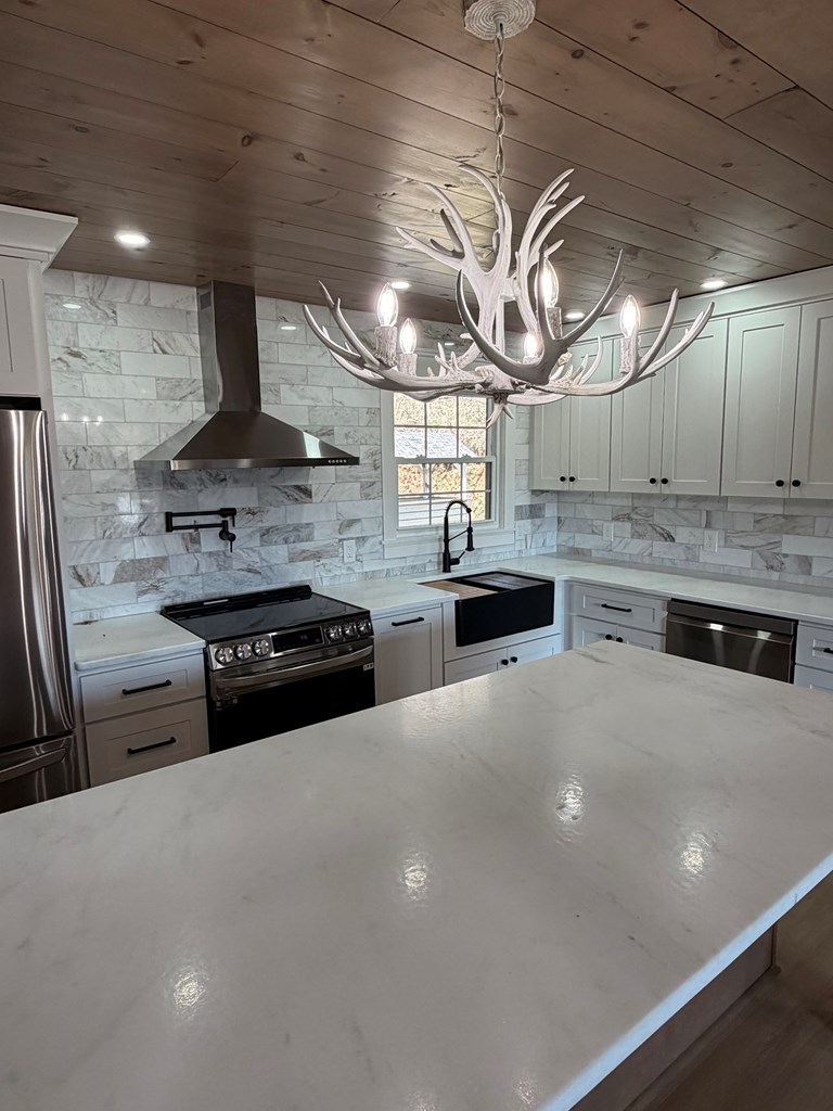 1819 Boardtown Road Ellijay, GA 30540 - Photo 4 of 13 a kitchen with stainless steel appliances granite countertop a sink a stove and a refrigerator