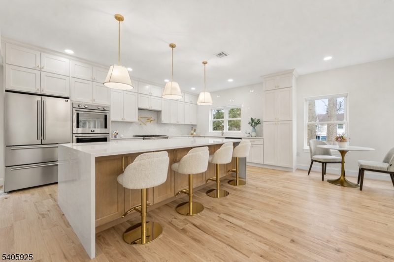 100 Louis Street Whippany, NJ 07981 - Photo 14 of 47 a kitchen with stainless steel appliances granite countertop a dining table chairs and sink
