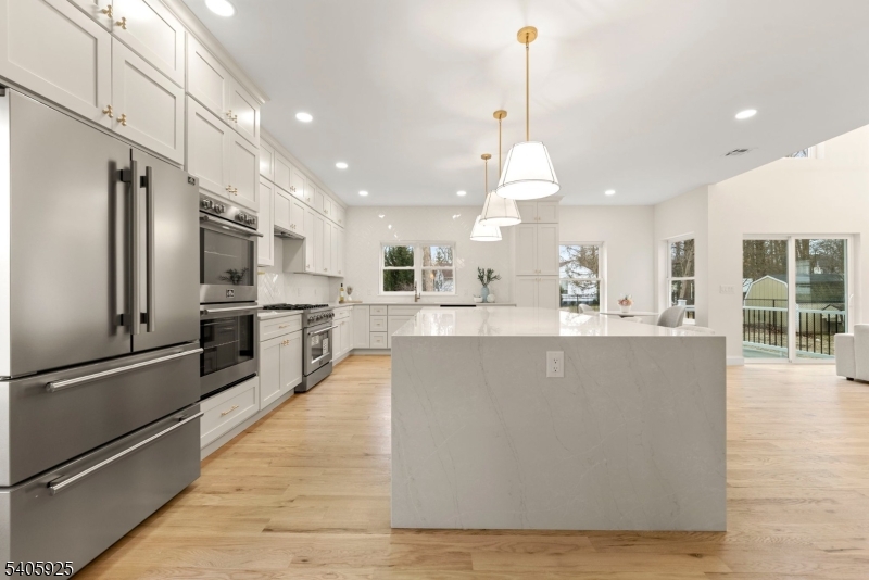 100 Louis Street Whippany, NJ 07981 - Photo 17 of 47 a large kitchen with kitchen island a large counter top stainless steel appliances and cabinets