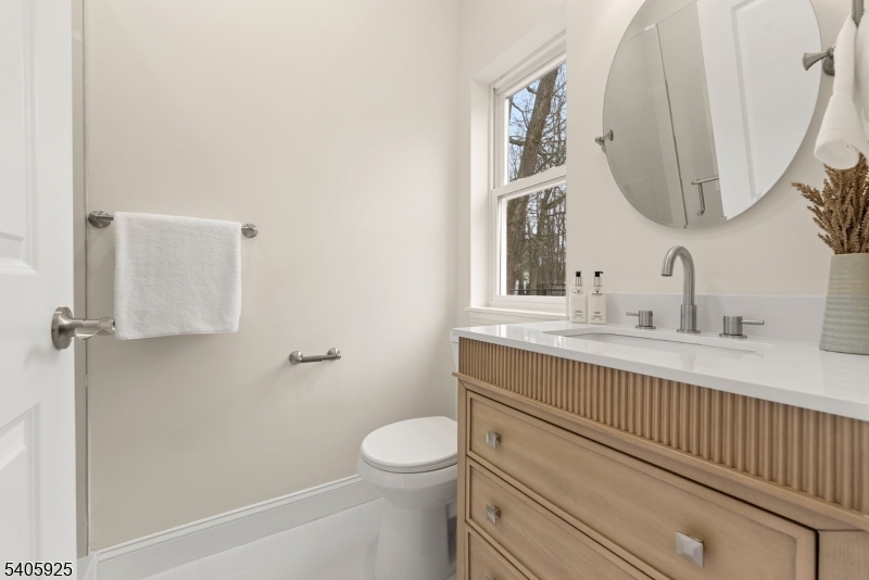 100 Louis Street Whippany, NJ 07981 - Photo 23 of 47 a bathroom with a toilet a sink and mirror