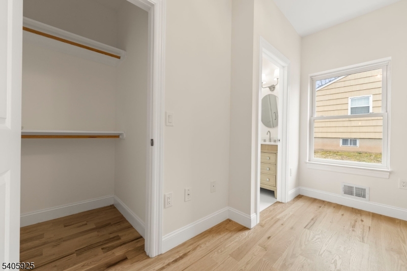 100 Louis Street Whippany, NJ 07981 - Photo 25 of 47 an empty room with wooden floor and windows