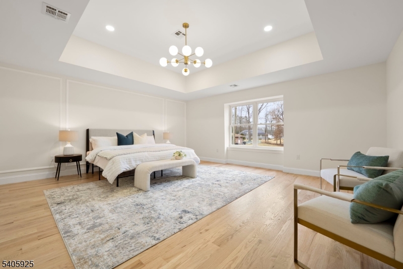 100 Louis Street Whippany, NJ 07981 - Photo 26 of 47 a spacious bedroom with a bed and wooden floor